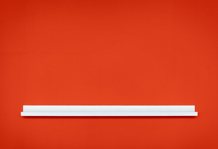 Close up of small empty white shelf  on wall.の写真素材