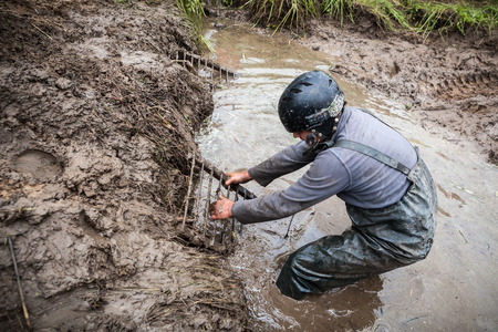LUBOTIN, UKRAINE - JULY 23, 2016: RFC Ukraine Wild Boar Challenge 2016. Pilot tries to get recovery sand tracks from deep mud.のeditorial素材