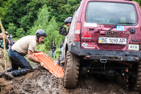LUBOTIN, UKRAINE - JULY 23, 2016: RFC Ukraine Wild Boar Challenge 2016. Team using recovery sand tracks to overcome a hard pit.のeditorial素材