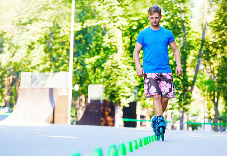 Close up of Inline roller skater on a slalom course.