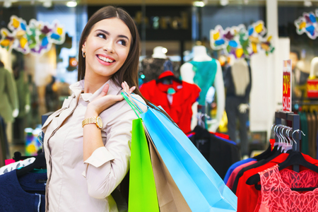 Portrait of beautiful young woman with shopping bags going out on a shopping spree.の写真素材