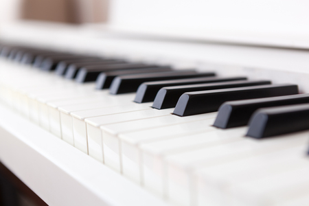 Close up of black and white piano keys. Shallow deep of field.の写真素材