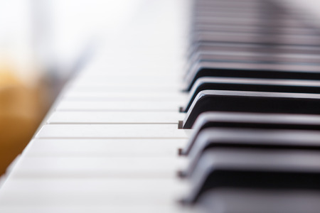 Close up of black and white piano keys. Shallow deep of field.の写真素材