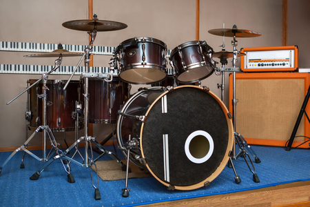 Music rehearsal space with drum kit and musical equipment.の写真素材