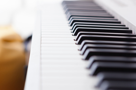 Close up of black and white piano keys. Shallow deep of field.の写真素材