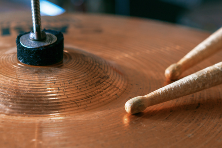 Close up of a pair of drumsticks lying on cymbal.の写真素材