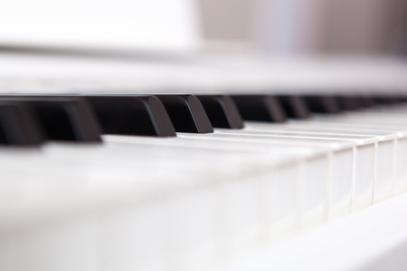 Close up of black and white piano keys. Shallow deep of field.の写真素材
