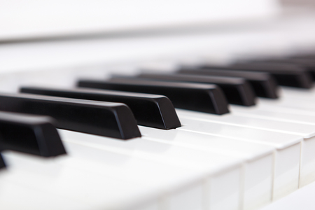 Close up of black and white piano keys. Shallow deep of field.の写真素材