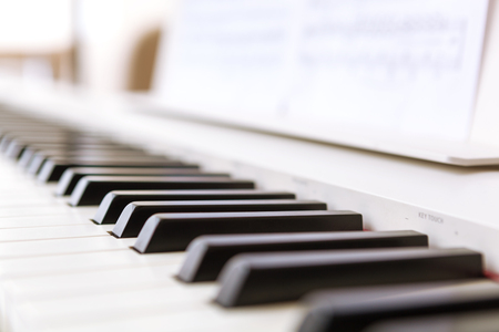 Close up of black and white piano keys. Shallow deep of field.の写真素材