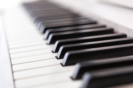 Close up of black and white piano keys. Shallow deep of field.の写真素材