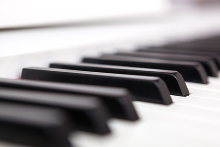 Close up of black and white piano keys. Shallow deep of field.の写真素材