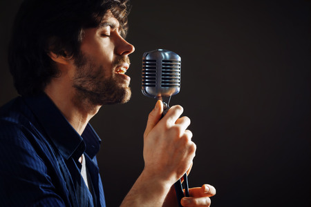 Handsome rock singer with retro microphone.の写真素材
