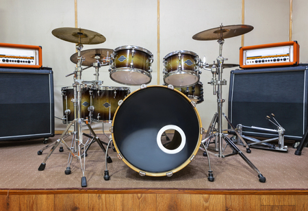Music rehearsal space with drum kit and musical equipment.の写真素材