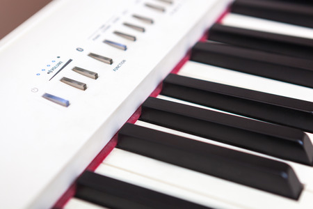 Close up of black and white piano keys. Shallow deep of field.の写真素材