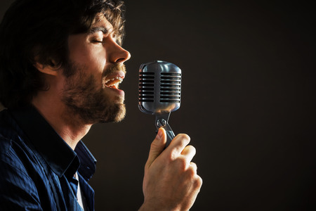 Handsome rock singer with retro microphone.の写真素材