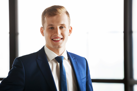 Portrait of young happy business man looking at camera.の写真素材