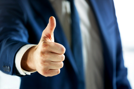 Cropped shot of business person showing thumb up.の写真素材