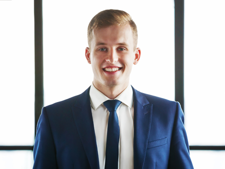 Portrait of young handsome business man looking at camera.の写真素材