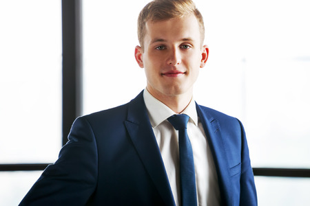 Portrait of young handsome business man looking at camera.の写真素材