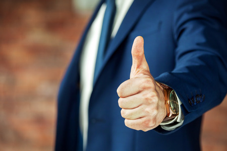 Cropped shot of business person showing thumb up.の写真素材