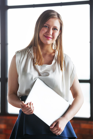 Portrait of happy young business woman looking at camera.の写真素材