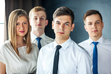 Group of young business people standing and looking at camera.の写真素材