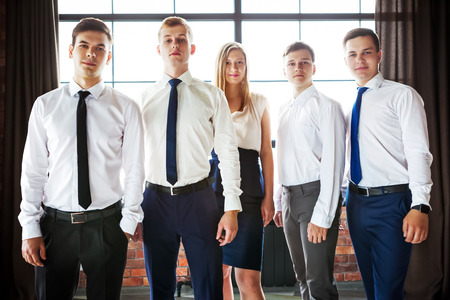 Group of young business people standing and looking at camera.の写真素材