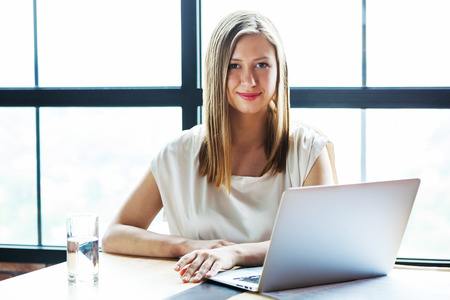 Portrait of happy young business woman looking at camera.の写真素材