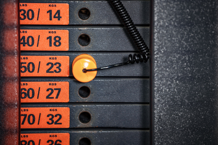 Old weight stack with pin in a fintess equipment.