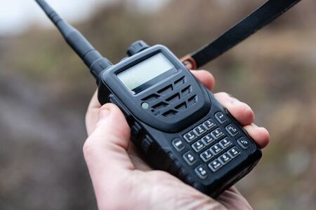 Close up of male holding walkie talkie.の写真素材