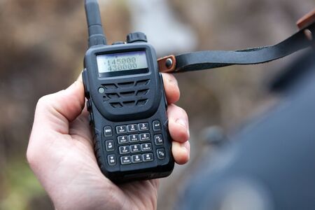 Close up of male holding walkie talkie.の写真素材