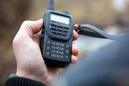 Close up of male holding walkie talkie.の写真素材