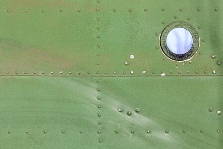 Close up of old aircraft green painted aluminum texture with rivets.の写真素材