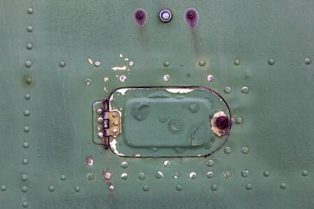 Close up of old aircraft green painted aluminum hatch with rivets.の写真素材