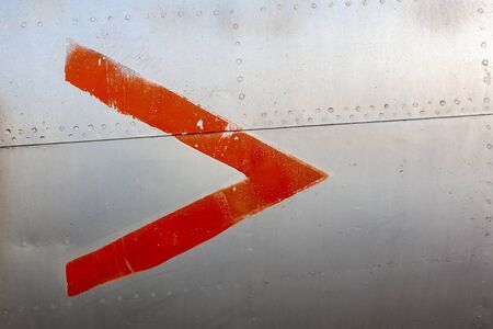 Close up of old aircraft aluminum panel with red arrow.の写真素材