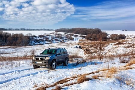Front view of Offroad car climbing winter hill. Winter travel concept.の写真素材