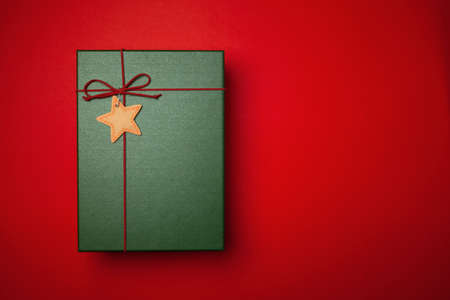 Green present or Christmas box on a red background.の写真素材
