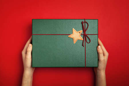 Green present or Christmas box on a red background.の写真素材