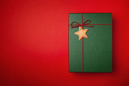 Green present or Christmas box on a red background.の写真素材