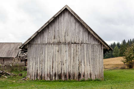 Front view of an old weathered wooden barn.の写真素材
