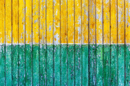 Group of vertical wooden panels painted yellow and green.の写真素材