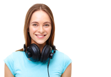 Portrait of young woman with headphones around her neck - isolated on white background.の写真素材