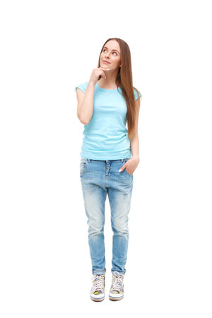 Full length portrait of young girl in casual clothing isolated on white.の写真素材