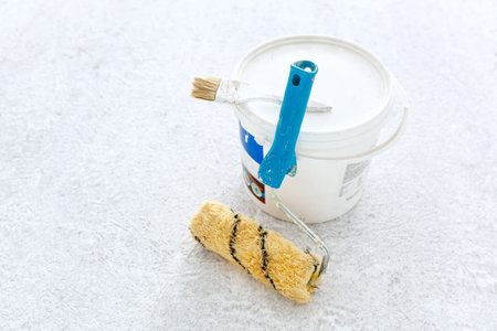 Paint bucket with roller brush on white background.Renovation concept.の写真素材