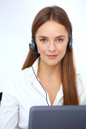 Portrait of beautiful young support phone operator with headset.の写真素材
