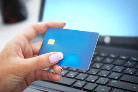 Woman hand holding credit card closeup. Online shopping concept.の写真素材