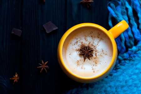 Cup of hot coffee on rustic wooden table, closeup photo warm sweater with mug, winter morning concept, top viewの写真素材