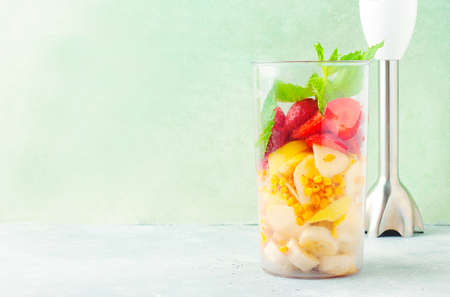 Blender filled with different fruits for smoothieの写真素材