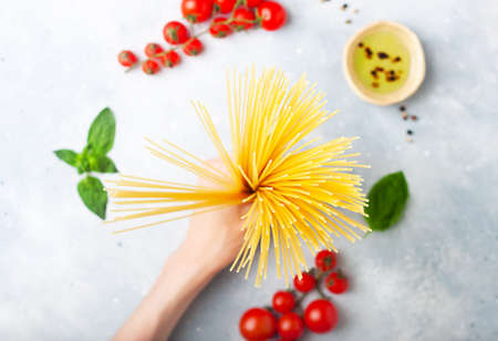 Italian food - pasta ingredients concept on grey stone background, copy space, flat layの写真素材
