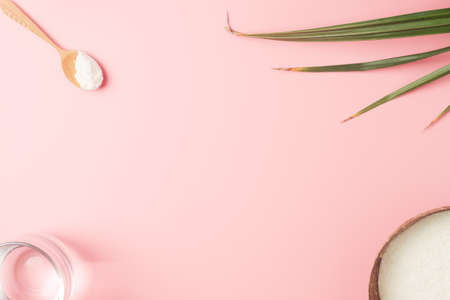 Collagen powder with palm leaves on pink background. Extra protein intake. Natural beauty and health supplement for skin, bones. Plant based collagen concept. Flat lay, top view. Copy space.の写真素材